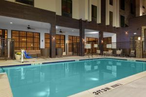 a large swimming pool in a hotel lobby at Hilton Garden Inn Waco in Waco