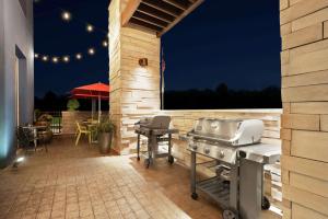 an outdoor patio with a grill and a table with a table at Home2 Suites By Hilton Columbia Harbison in Columbia