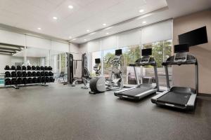 a gym with several treadmills and machines in a room at Home2 Suites By Hilton Columbia Harbison in Columbia