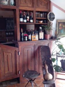 a wooden cabinet with bottles of wine in a room at Apartment Relax in Zrenjanin +24 photos