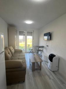 a living room with a couch and a table at Apartments Linic in Nin