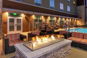 a hotel lobby with a fire pit and a pool at Hampton Inn & Suites Buena Park in Buena Park