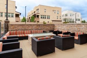 a patio with chairs and tables on a building at Hampton Inn & Suites Buena Park in Buena Park