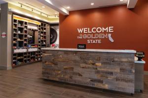 a welcome to the golden state sign on a store lobby at Hampton Inn & Suites Buena Park in Buena Park