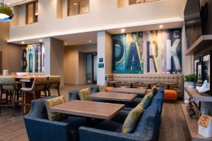 a restaurant with blue couches and tables and a bar at Hampton Inn & Suites Buena Park in Buena Park