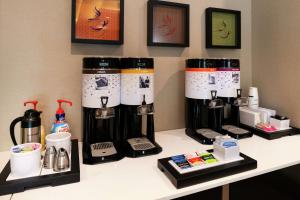 a counter with several coffee machines on a table at Hampton Inn & Suites Buena Park in Buena Park