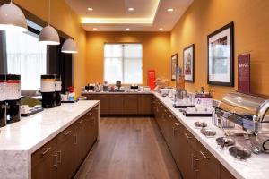 a large kitchen with a large long counter top at Hampton Inn & Suites Buena Park in Buena Park