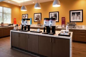 a salon with a counter with wine bottles on it at Hampton Inn & Suites Buena Park in Buena Park