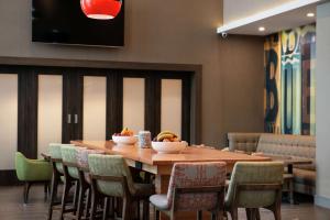 a dining room with a wooden table and chairs at Hampton Inn & Suites Buena Park in Buena Park