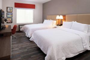 a hotel room with two beds and a window at Hampton Inn & Suites Buena Park in Buena Park