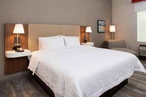 a large white bed in a hotel room at Hampton Inn & Suites Buena Park in Buena Park