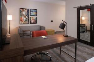 a living room with a desk and a couch at Hampton Inn & Suites Buena Park in Buena Park