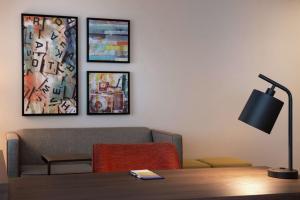 a living room with a couch and a table with a lamp at Hampton Inn & Suites Buena Park in Buena Park