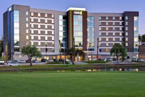 a hotel with a green field in front of a building at Home2 Suites by Hilton Los Angeles Montebello in Montebello