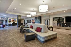 a living room with a couch and a dining room at Home2 Suites by Hilton Los Angeles Montebello in Montebello