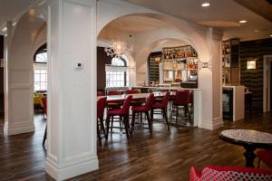 a restaurant with a table and chairs and a bar at The Sire Hotel Lexington, Tapestry Collection by Hilton in Lexington