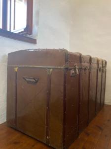 an old brown trunk sitting on a wooden floor at Terra Petra Mani in Koíta