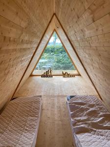 a room with two beds and a large window at Sörby Glamping in Klockrike