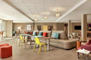 a lobby with a couch and tables and chairs at Home2 Suites By Hilton San Antonio North Stone Oak in San Antonio
