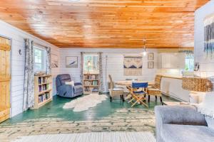 a living room with a table and chairs at Sand Dollar Cottage Rockaway - Meredith Lodging in Rockaway Beach