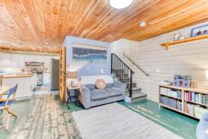 a living room with a bed and a kitchen at Sand Dollar Cottage Rockaway - Meredith Lodging in Rockaway Beach