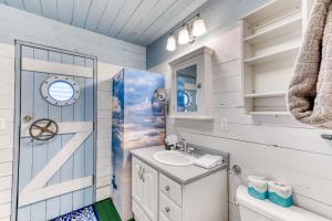 a white bathroom with a sink and a shower at Sand Dollar Cottage Rockaway - Meredith Lodging in Rockaway Beach +47 photos