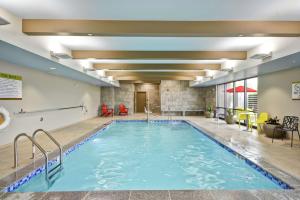 a pool in the lobby of a hotel at Home2 Suites By Hilton Portland Airport in South Portland