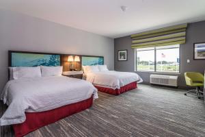 a hotel room with two beds and a window at Hampton Inn & Suites - Allen Park in Allen Park