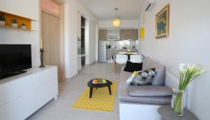 a living room with a couch and a tv at Apartments Kamelija in Split