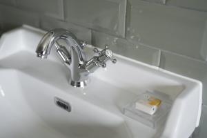 a sink with a faucet and a bar of soap at The Windmill in Maidstone