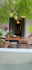 a table and chairs with plates and flowers on it at Rustic in Vir