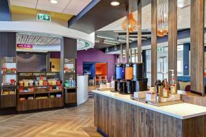 a coffee shop with a counter in a store at Tru By Hilton Edmonton Windermere in Edmonton