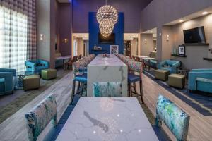 a dining room with a long table and chairs at Hampton Inn & Suites Dallas/Plano Central in Plano