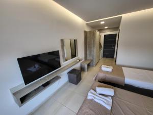 a hotel room with a large flat screen tv at RADINA FAMILY in Kallithea Halkidikis