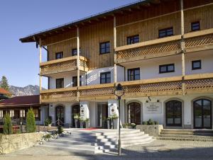 a large building with a staircase in front of it at Seehotel Waltershof in Rottach-Egern