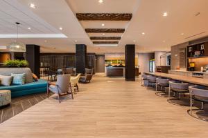 a lobby of a hotel with a bar and chairs at Home2 Suites By Hilton Nashville Bellevue in Bellevue