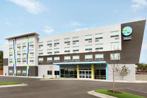 a large white building with a sign on it at Tru By Hilton Harbison Columbia in Columbia