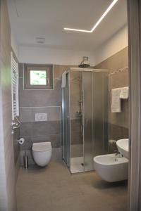 a bathroom with a shower and a toilet and a sink at Paradiso degli Ulivi B&B in Peschiera del Garda +21 photos