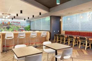 a classroom with tables and chairs and a counter at Tru By Hilton Harbison Columbia in Columbia