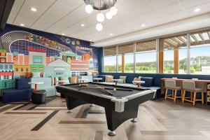 a billiard room with a pool table and a mural at Tru By Hilton Florence I-95 in Florence