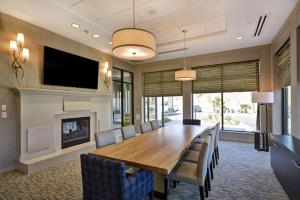 a dining room with a table and a fireplace at Hilton Garden Inn Gastonia in Gastonia