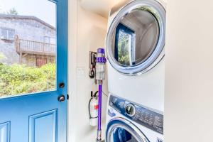 a washer and dryer in a laundry room with a door at Casabonita (MCA #50604) in Manzanita