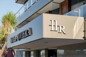 a building with a sign for the hrt at Riviera Hotel & Spa in Villa Carlos Paz