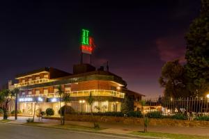 a hotel with a neon sign on top of it at Riviera Hotel & Spa in Villa Carlos Paz +69 photos