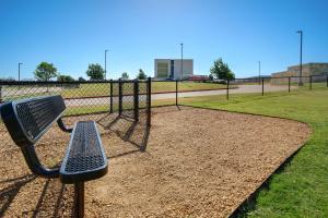 a park bench in front of a batting cage at Home2 Suites Plano Legacy West in Plano