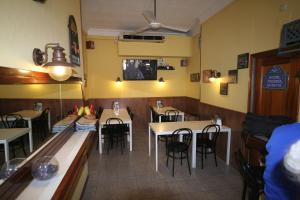 a dining room with tables and chairs in a restaurant at Hostal Juventus in Portbou