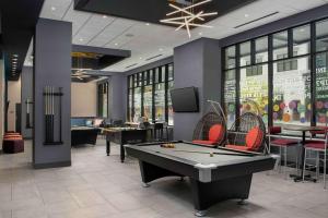 a billiard room with a pool table and chairs at Tru By Hilton Nashville Downtown Convention Center in Nashville