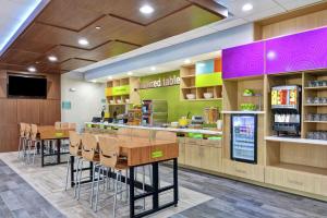 a fast food restaurant with chairs and a counter at Home2 Suites By Hilton Bedford Dfw West in Bedford