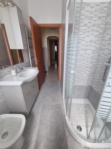 a bathroom with a shower and a toilet and a sink at Appartamento Valentinis 74 in Monfalcone