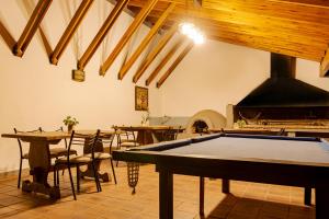 a pool table in a room with tables and an oven at Riviera Hotel & Spa in Villa Carlos Paz